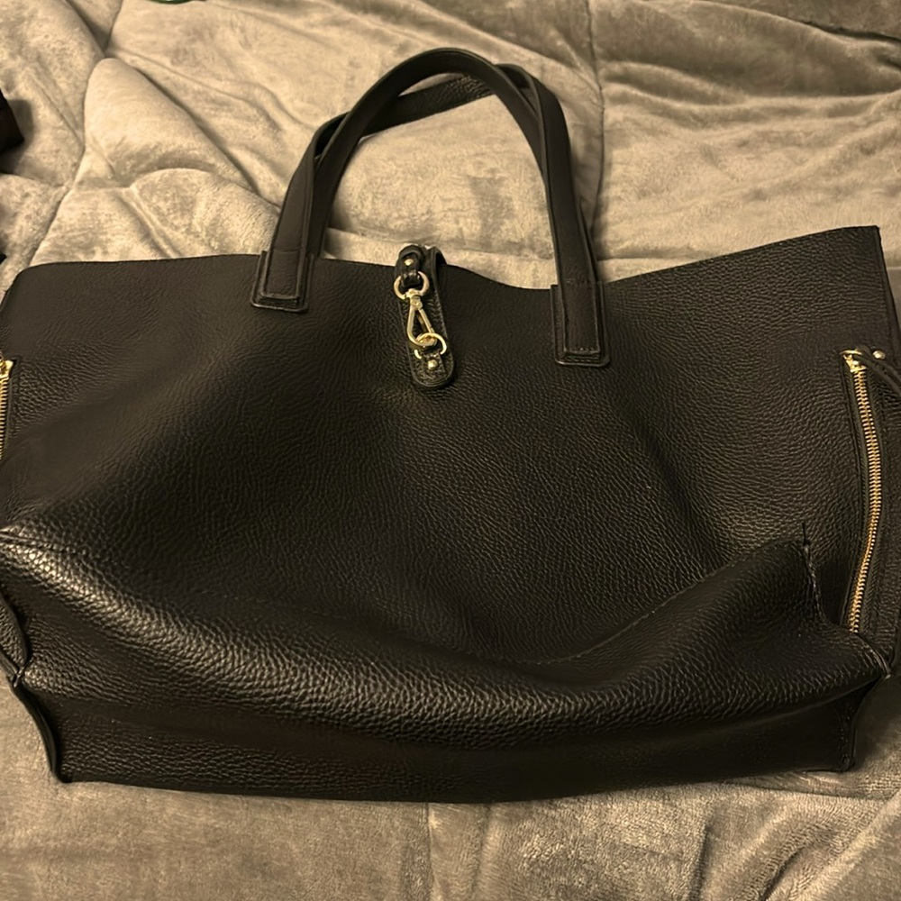 Black tote with navy lining pockets inside and out.